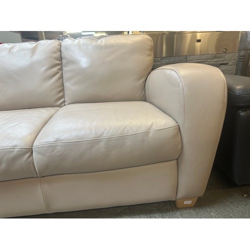 1509 - A beige leather two seater sofa