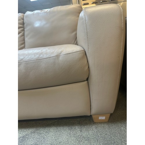 1509 - A beige leather two seater sofa