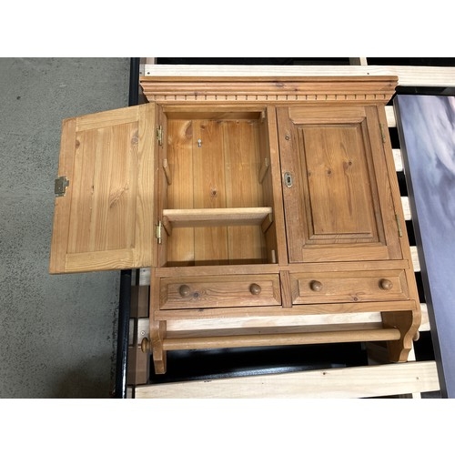 1546 - A pine bathroom/kitchen cabinet with towel rail