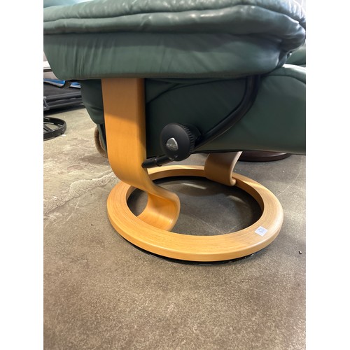 1490 - A green upholstered reclining swivel armchair