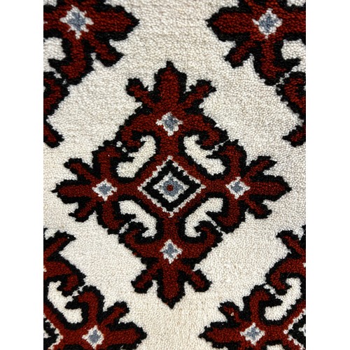 1489 - A large brown and cream rug and a white ground floor runner