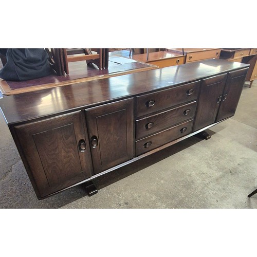 136 - An Ercol dark elm Windsor sideboard