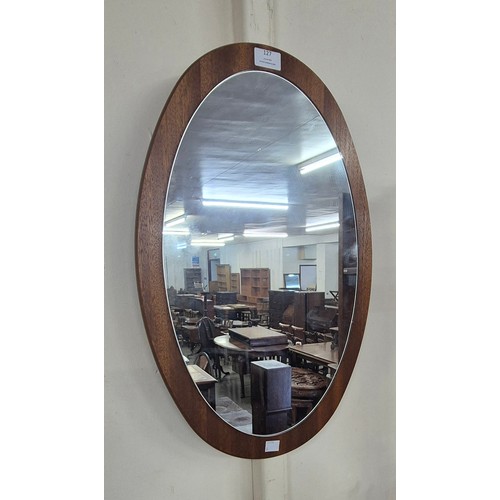 127 - A teak oval framed mirror