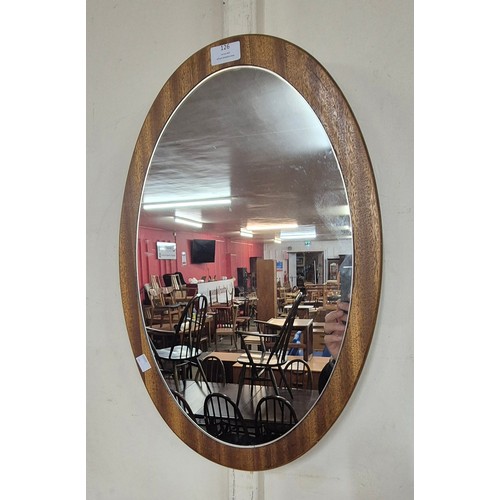 126 - A teak oval framed mirror