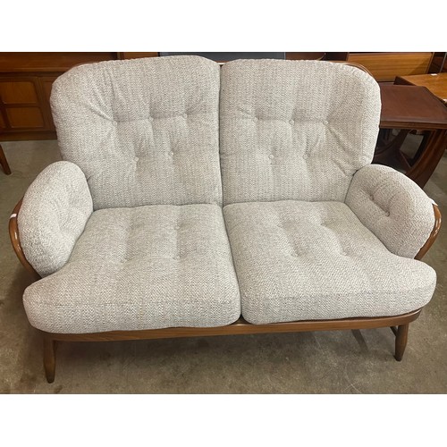 123 - An Ercol Golden Dawn beech Jubilee settee and armchair