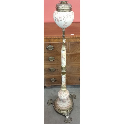 156 - A late 19th Century brass and pottery standard oil lamp, the polygonal tapered reservoir, cylindrica... 