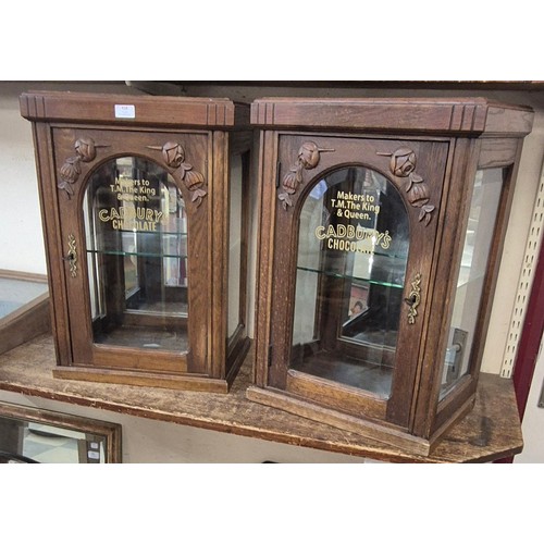 418 - A pair of early 20th Century oak counter top shop cabinets, bearing Cadbury's Chocolate inscription ... 