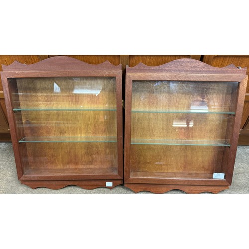 436 - Two teak wall mounted display cabinets