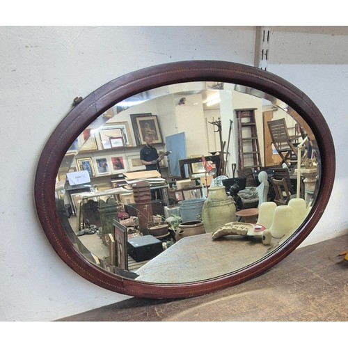 417A - An Edward VII inlaid mahogany framed oval mirror