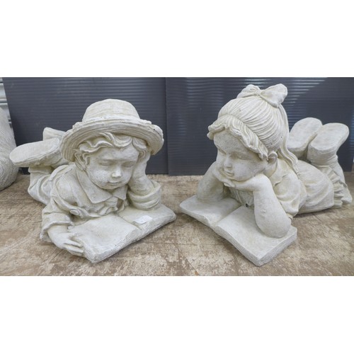 2309 - Two stone effect concrete garden ornaments of children reading