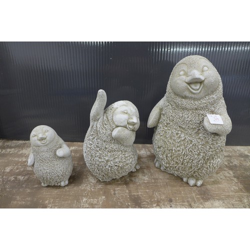 2318 - Three stone effect concrete penguins