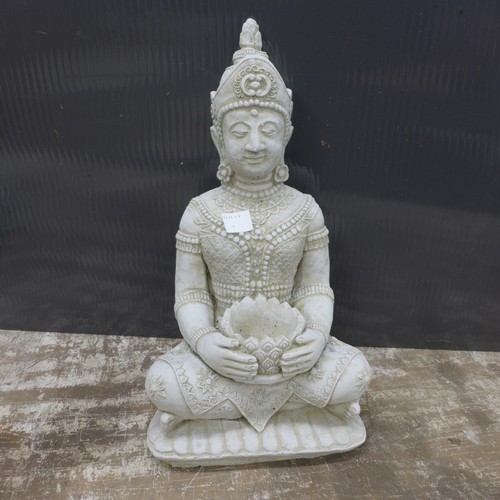 2323 - A stone effect concrete ornament of Buddha holding a candle