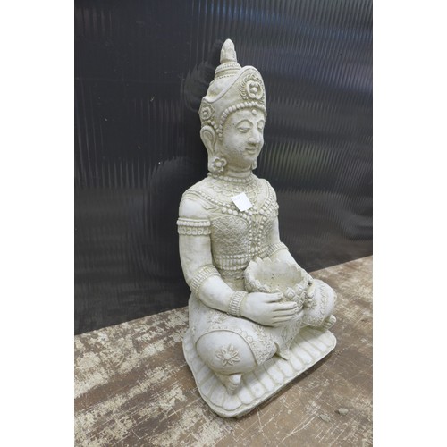 2323 - A stone effect concrete ornament of Buddha holding a candle