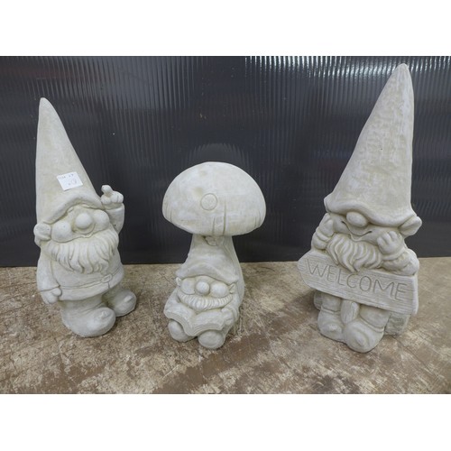 2324 - A trio of stone effect concrete gonk garden ornaments