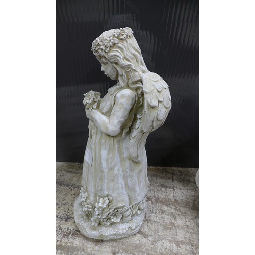 2331 - A stone effect concrete figure of an angel with a bouquet of flowers