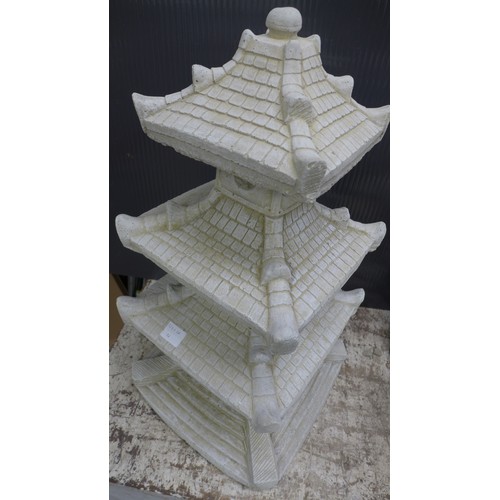 2331A - A stone effect concrete ornament of an oriental four tier pagoda