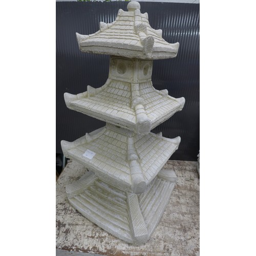 2331A - A stone effect concrete ornament of an oriental four tier pagoda