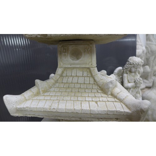 2331A - A stone effect concrete ornament of an oriental four tier pagoda