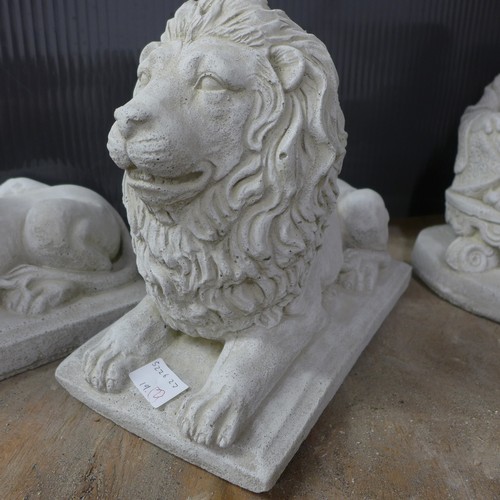 2333 - A pair of small stone effect concrete ornaments of lions laying down