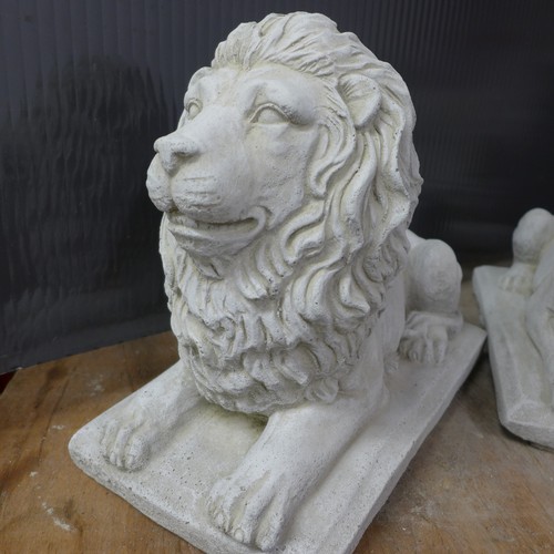 2333 - A pair of small stone effect concrete ornaments of lions laying down