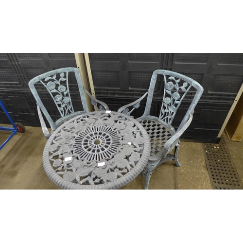 2363 - A grey plastic cast iron effect garden table and 2 chairs