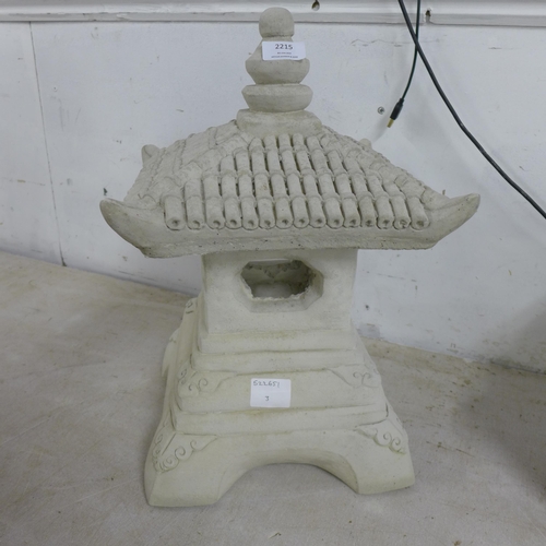 2215 - 2 stone effect concrete Buddha figures and a stone effect concrete oriental style pagoda