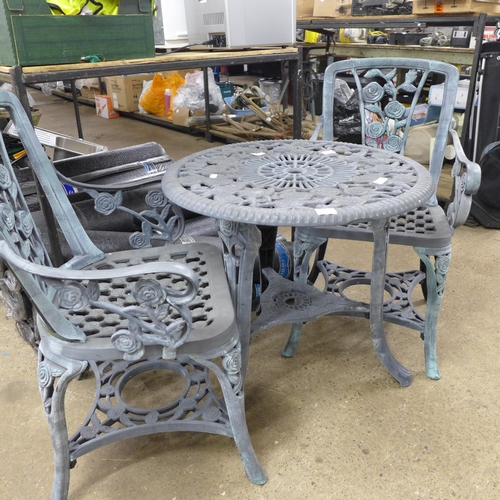 2363 - A grey plastic cast iron effect garden table and 2 chairs