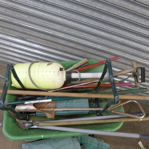 2365 - A plastic wheelbarrow and an assortment of garden tools including lawn edging shears, rakes, branch ... 