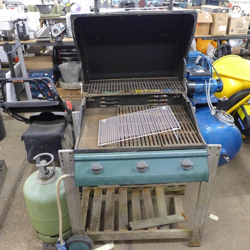 2367 - An Outback three burner gas barbecue with a part full calor gas bottle