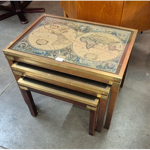 71 - A mahogany and brass mounted nest of tables, top inset with map of the world