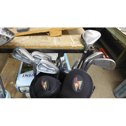 2052 - Three golf bags including a Dunlop, a Cobra and a Hippo bag plus a large quantity of golf clubs incl... 