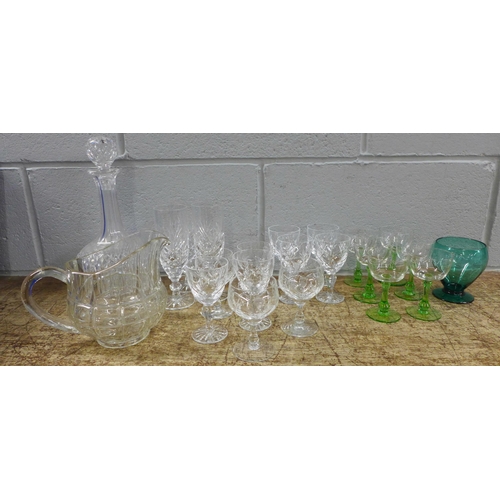 1006 - A collection of glassware including a set of etched drinking glasses, green stem glasses, crystal an... 