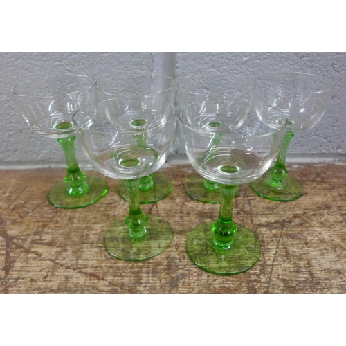 1006 - A collection of glassware including a set of etched drinking glasses, green stem glasses, crystal an... 