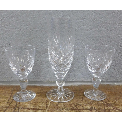 1006 - A collection of glassware including a set of etched drinking glasses, green stem glasses, crystal an... 