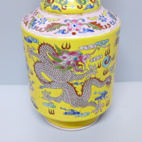 603 - A Chinese porcelain vase on yellow ground with dragon detail, six character mark to base, 23cm