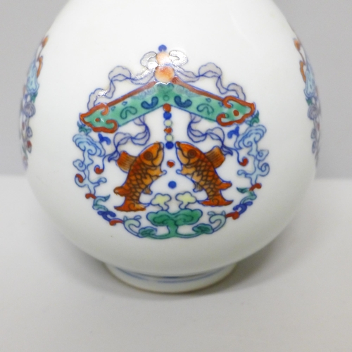 604 - A Chinese porcelain Doucai bottle vase, 22.5cm