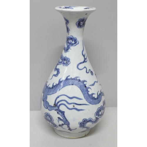 605 - A Chinese porcelain blue and white vase decorated with a dragon and clouds, 26.5cm