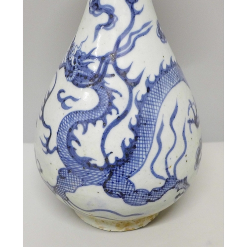 605 - A Chinese porcelain blue and white vase decorated with a dragon and clouds, 26.5cm