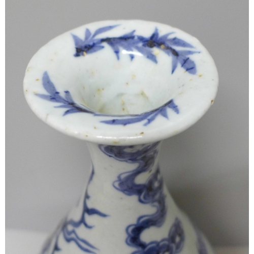 605 - A Chinese porcelain blue and white vase decorated with a dragon and clouds, 26.5cm