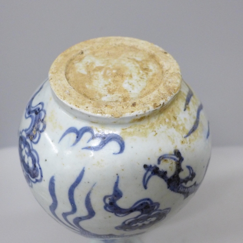 605 - A Chinese porcelain blue and white vase decorated with a dragon and clouds, 26.5cm