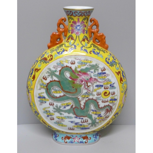 616 - A Chinese moon vase with dragon detail, 28cm