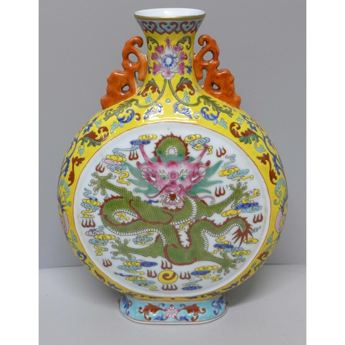 616 - A Chinese moon vase with dragon detail, 28cm