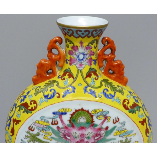 616 - A Chinese moon vase with dragon detail, 28cm