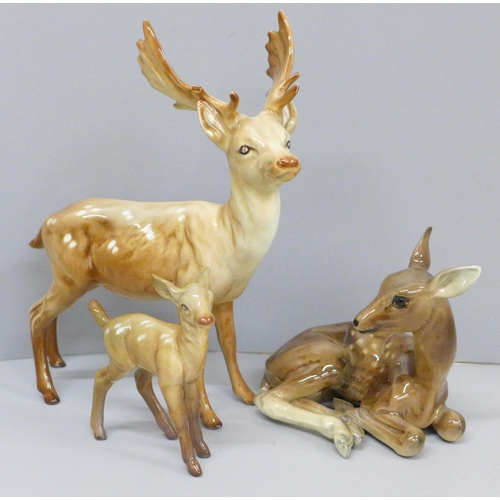 642 - A Beswick stag, doe and fawn, one antler on stag chipped