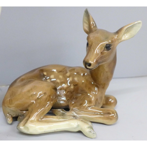 642 - A Beswick stag, doe and fawn, one antler on stag chipped