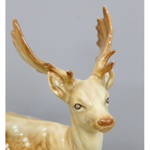 642 - A Beswick stag, doe and fawn, one antler on stag chipped