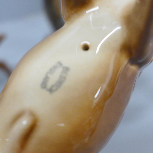 642 - A Beswick stag, doe and fawn, one antler on stag chipped