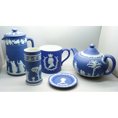 662 - A Wedgwood dark blue Jasperware teapot, mug, pitcher,  and cylindrical vase and pin tray