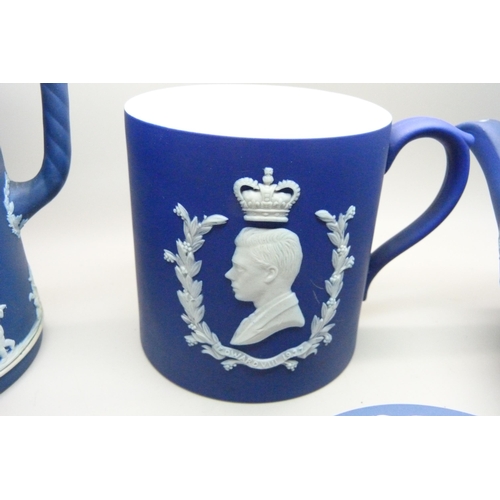 662 - A Wedgwood dark blue Jasperware teapot, mug, pitcher,  and cylindrical vase and pin tray