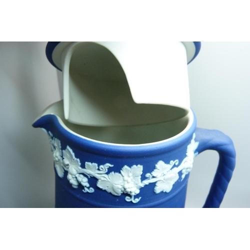 662 - A Wedgwood dark blue Jasperware teapot, mug, pitcher,  and cylindrical vase and pin tray